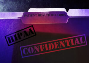 Confidential Patient Health Records folder with HIPAA stamp. Managed IT security concept.